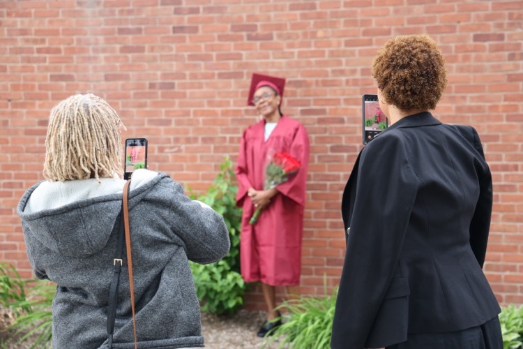 family of Doreen Chambers take photos of the graduate. 